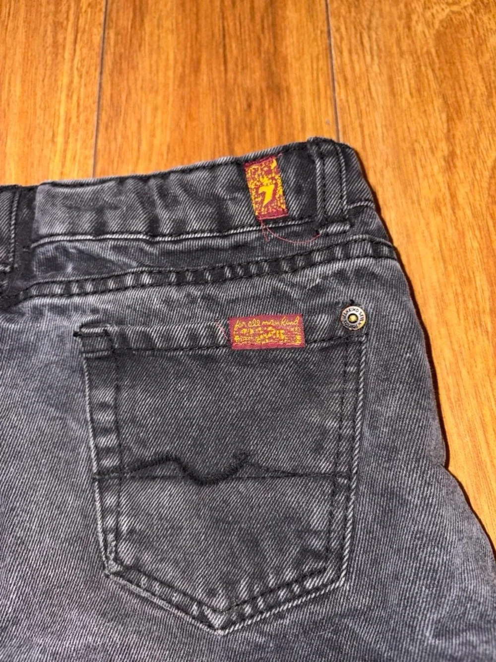Black denim shorts with a distressed look